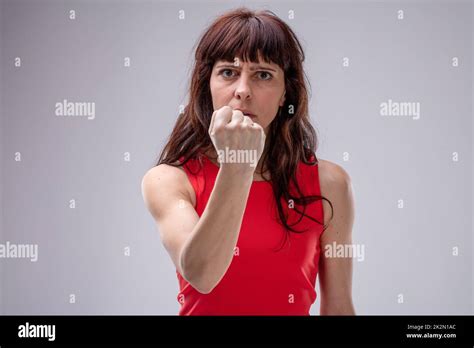 Angry Woman Gesturing With Her Clenched Fist Stock Photo Alamy