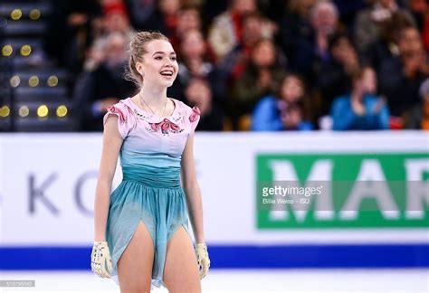 A Female Figure Skating On The Ice In Front Of An Audience