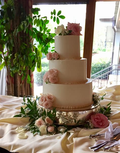 Simple Smooth Iced Buttercream Wedding Cake With Fresh Flowers Pink