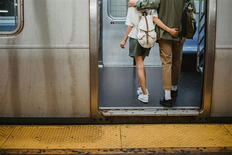 Unrecognizable Couple Cuddling While Standing In Metro Train · Free