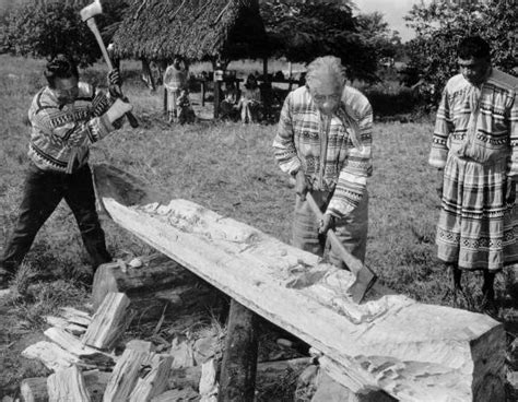 Florida Memory Seminole Men Chopping A Cypress Log Into A Canoe
