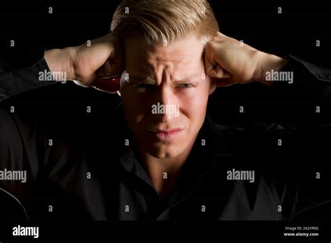 Low Key Portrait Of Overburdened Young Man Stock Photo Alamy