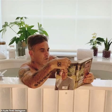 Robbie Williams Steps Into A Bath To Read Gary Barlows Autobiography