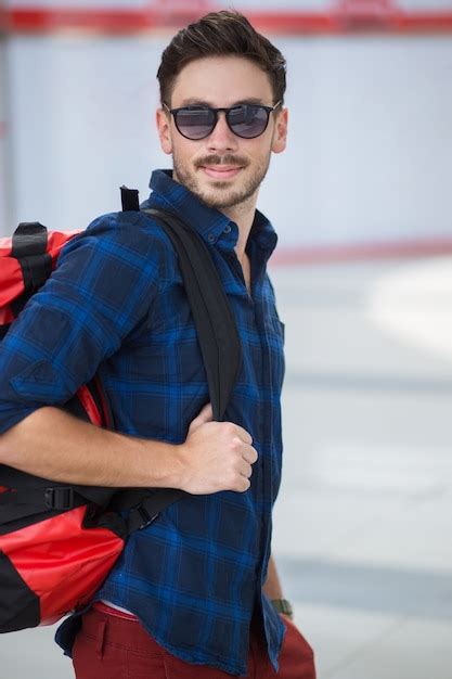 Free Photo Smiling Tourist With Backpack At Station