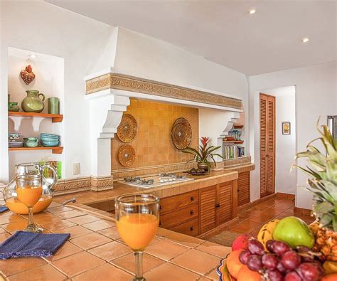 Traditional Mexican Kitchen With Sunny Yellow Tiles And Tropical