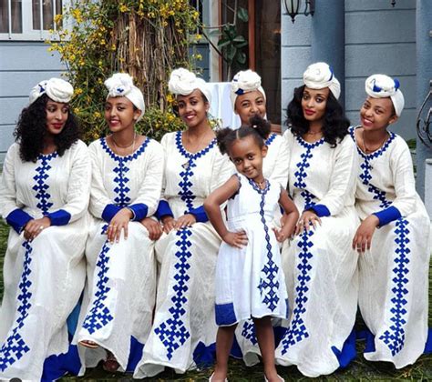 Ladies In White Habesha Kemis With Blue Embroidery And Headwrap