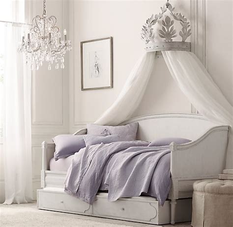 Ornate fabric is often draped between the posts and a solid swathe of cloth may create a ceiling, or canopy directly over the bed. Heirloom White Demilune Metal Canopy Bed Crown