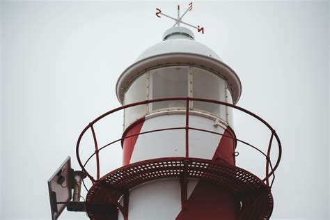 Beacon Of Lighthouse Against Cloudy Sky · Free Stock Photo