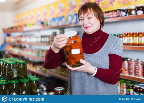 Cheerful Buyer Choosing Canned Jar Of Tomatoes Stock Image Image Of