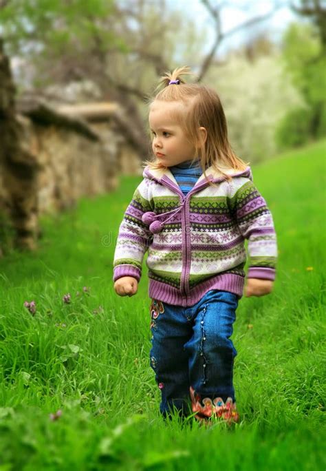 Little Girl Walks In The Spring On A Young Grass Stock Image Image Of