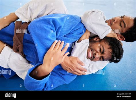 Men Martial Arts And Karate Choke Hold In Dojo To Practice Fighting