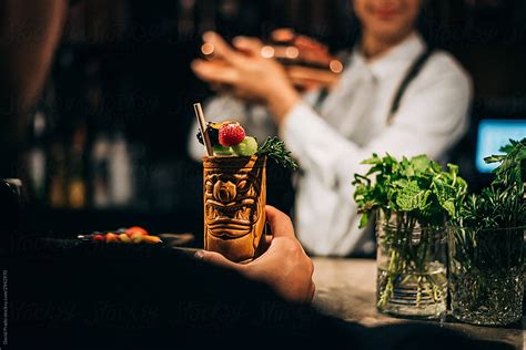 Crop Client Enjoying Tropical Cocktail In Bar Del Colaborador De Stocksy David Prado Stocksy