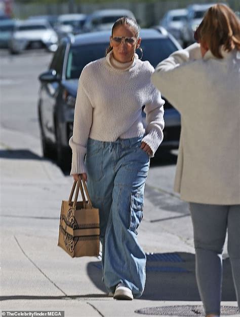 Jennifer Lopez Bundles Up In Cozy White Sweater And Baggy Blue Jeans At