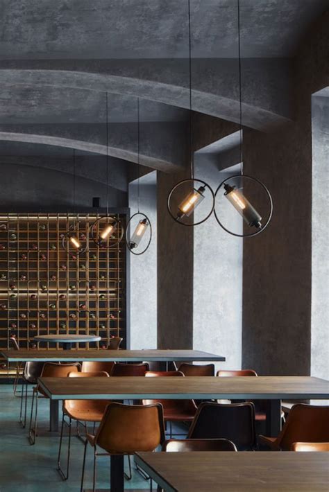 An Empty Restaurant With Wooden Tables And Chairs Wine Racks On The