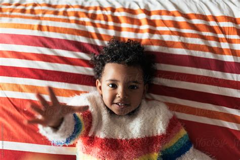 Portrait Of Happy Mixed Race Baby Looking At Camera Del Colaborador