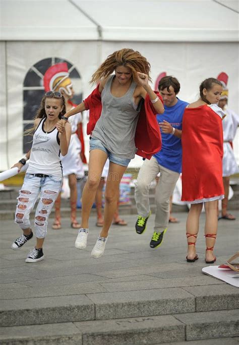 happy girls fooling around jumping over pavement on the street kyiv ukraine editorial stock