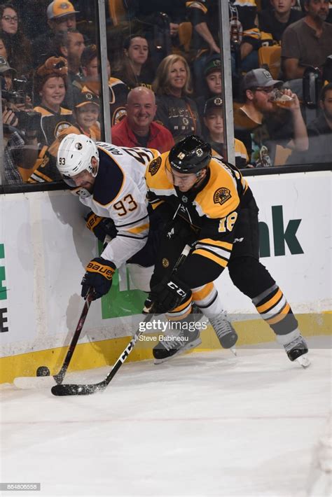 Kenny Agostino Of The Boston Bruins Fights For The Puck Against News