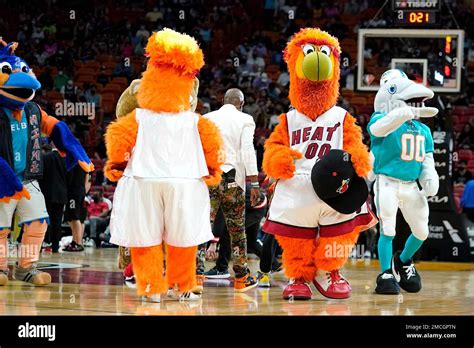 The Miami Heat Mascot Burnie Second From Right Stands On The Court