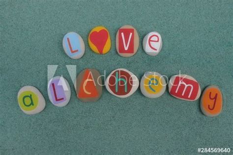 Love Alchemy Text Composed With Creative Carved And Colored Stones Over Green Sand Acquista