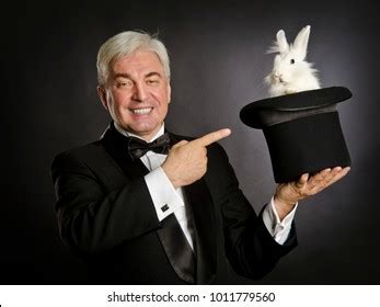 To produce something in a way that has no obvious explanation, as if done by magic. Magician Pulling Rabbit Out of a Hat Stock Photos, Images ...