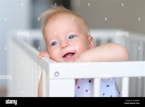 Baby Boy Standing In Crib Stock Photo Alamy