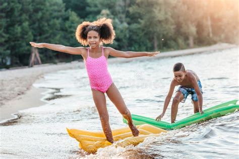 Happy African American Kids Having Fun With Swimming Mattresses Stock