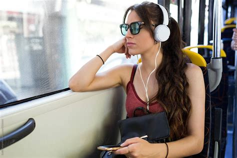 Casual Woman Listening To Music In Bus By Stocksy Contributor Guille