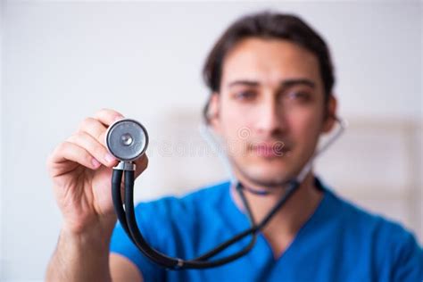 Young Male Doctor With Stethoscope Stock Photo Image Of Listening