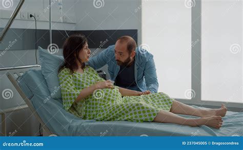 Pregnant Young Woman Going Into Labor In Hospital Ward Stock Image