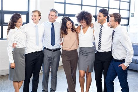 Premium Photo Business People Standing Together With Arms Around Each Other In Office