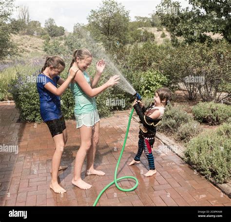 Teenage Boy Spraying Water Hose Hi Res Stock Photography And Images Alamy