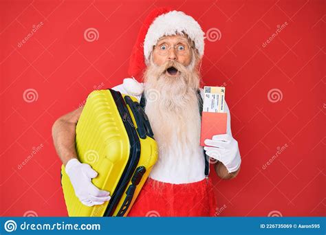 Old Senior Man Wearing Santa Claus Costume Holding Suicase And Boarding