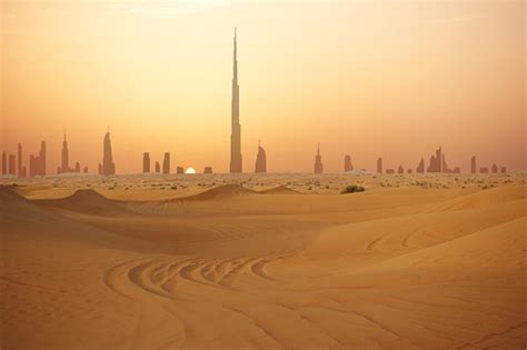 Skyline Of Dubai At Sunset Or Dusk View From Arabian Desert Stock Photo