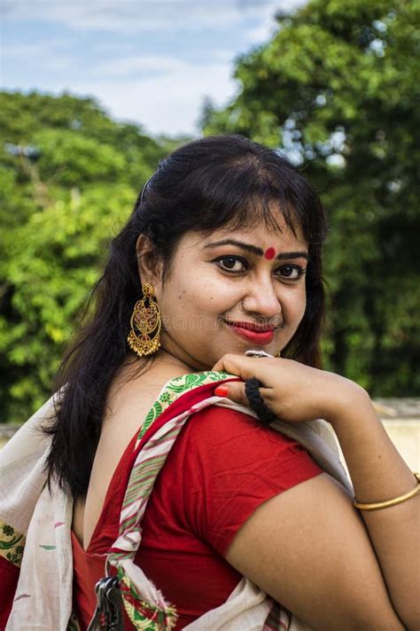 Beautiful Indian Female Model In Traditional Bengali Saree Looking Straight Happily With Slight