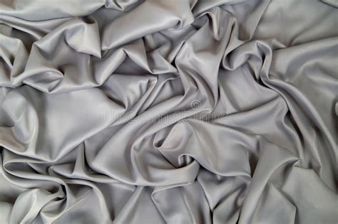 Soft Gray Metallic Fabric Lined With Waves And Folds Stock Photo