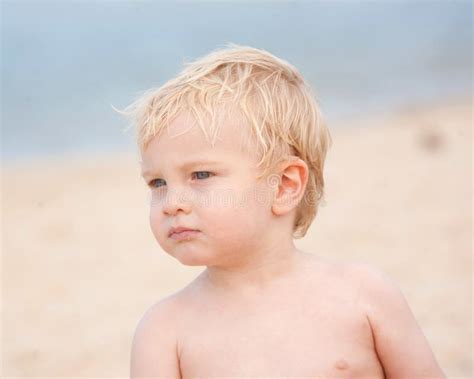 Um Rapaz Pequeno Bonito Na Praia Foto De Stock Imagem De Exterior
