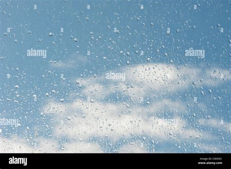 Raindrops On A Window In Front Of A Cloudy Blue Sky Stock Photo Alamy