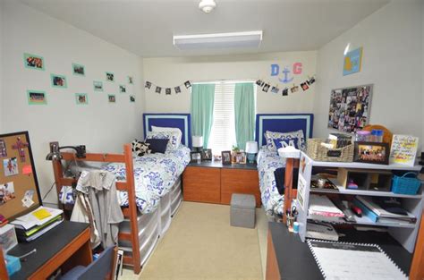 Two Twin Beds In A Room With Desks And Pictures On The Wall Above Them