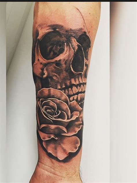 This tattoo has all the clichés of tattoo art, namely skulls, guns and roses, juxtaposed together to form a unique piece of art. My skull and rose tattoo, start of sleeve | Skull rose ...