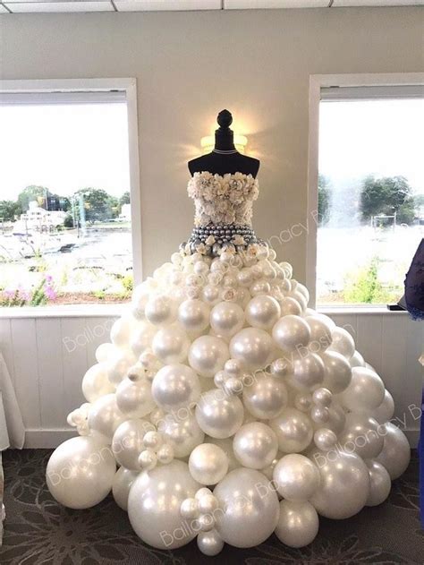 A Dress Made Out Of White Balloons On Display
