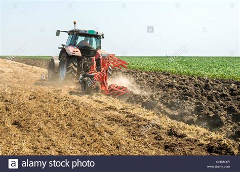 Tractor Plowing The Stubble Field Stock Photo Alamy