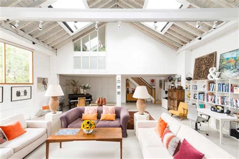 This garage conversion blends a home office and a small seating area complete with a couch for guests. 36 garage conversion ideas to add more living space to your home | loveproperty.com