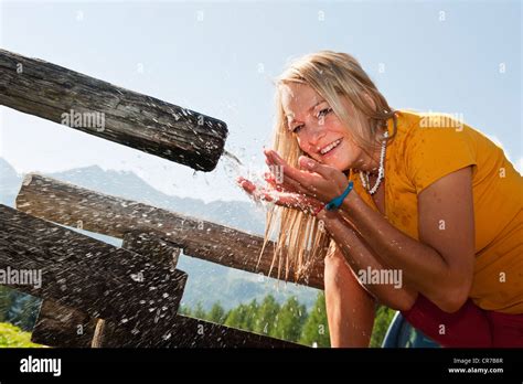 Austria Salzburg County Young Woman Drinking Water From Water Trough