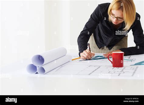 Female Architect Drawing On Blueprint Stock Photo Alamy