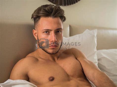 Shirtless Sexy Male Model Lying Alone On His Bed By Artofphoto Vectors