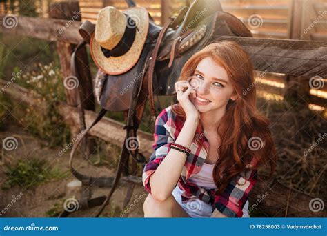 Close Up Portrait Of A Happy Beautiful Redhead Cowgirl Resting Stock