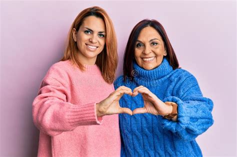 Latin Mother And Daughter Wearing Casual Clothes Smiling In Love Doing Heart Symbol Shape With