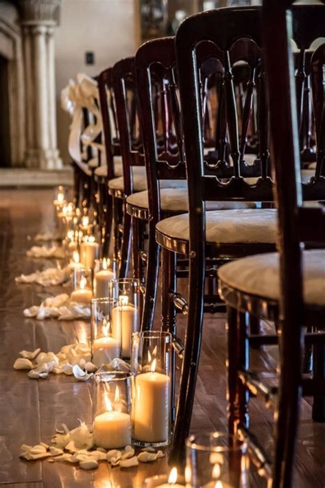Candles Surrounded By Petals Line The Aisle For An Indoor