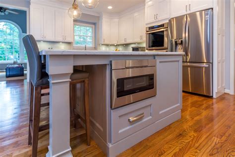Architect christian taeubert paired them with organic materials, rustic textures, and warm tones, which impart a modern twist on a bucolic space. Gray kitchen island with stainless steel microwave and ...