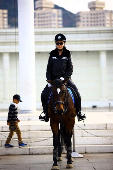 Dalians Mounted Policewoman In Full Leather Uniform Riding Helmets